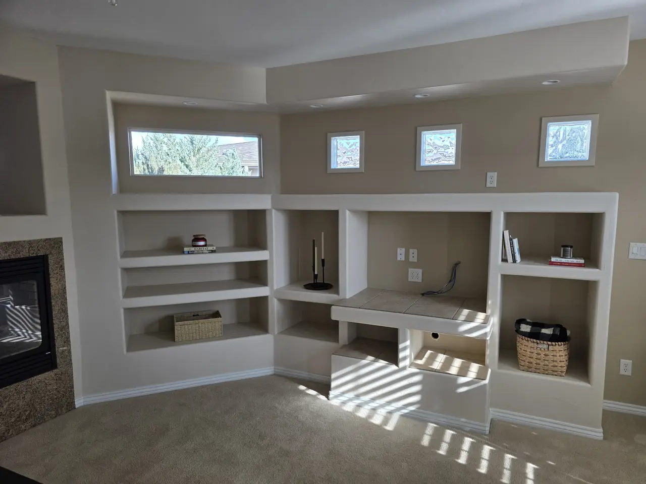 Painted built-in shelving and desk nook in warm afternoon light